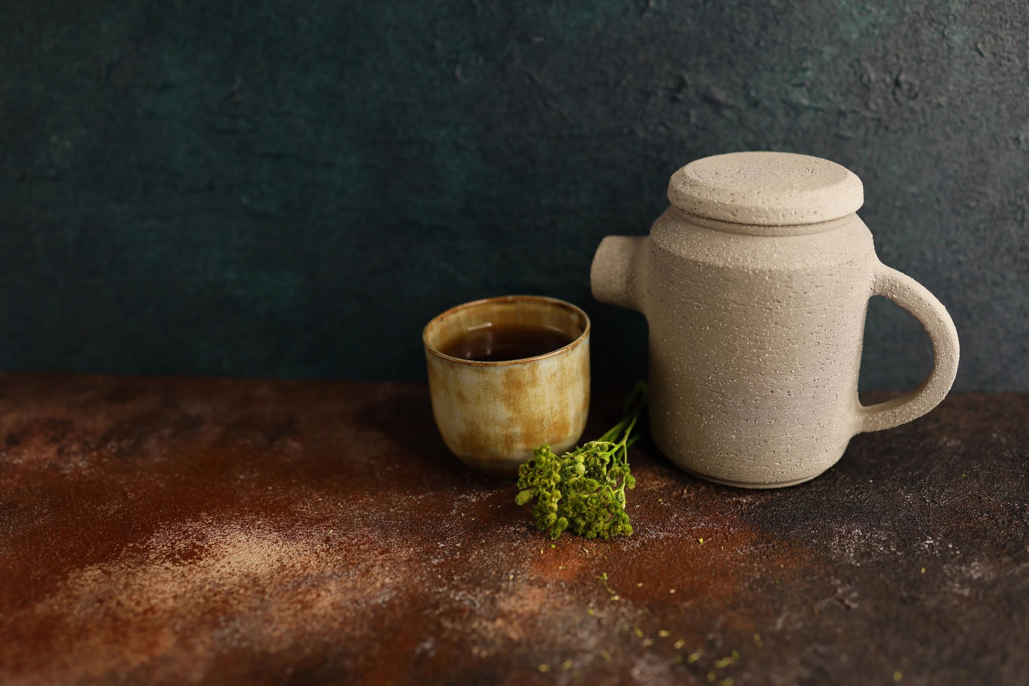 Ceramic teacup and rustic teapot still life